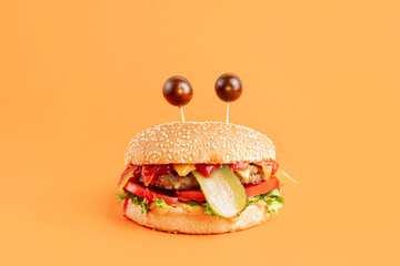 Funny Monster Burger on the orange background
