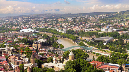 View from the height of the center of Tbilisi, Georgia. Rike Park, Kura River, a futuristic exhibition hall and a musical concert. Bridge of Peace. Air balloon. Beautiful panorama of the old town © yaroslav1986