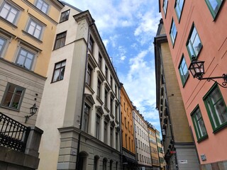 A street lined with colorful houses in Stockholm's historic Gamla Stan district, Sweden