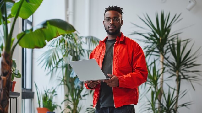 The man holding laptop.