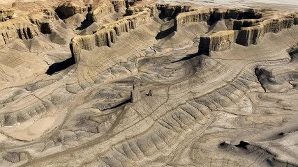 Aerial view of breathtaking rock formations and rugged canyon in Swing Arm City, Caineville, Utah, United States.