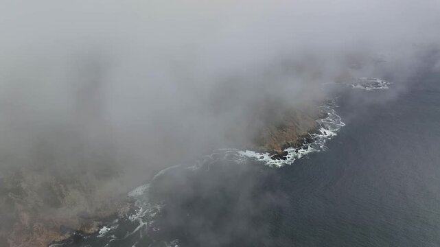 Aerial view of fog and mist enveloping the serene landscape of Point Reyes Headlands ASBS, Inverness, California, United States.