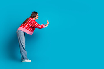 Full size photo of adorable woman dressed knitwear cardigan pushing object in empty space say stop...