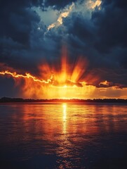 Sun setting behind a line of thunderstorms on the horizon, dramatic weather, contrast of light and dark