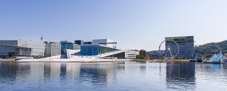 Oslo, Norway - August 2, 2024: Panoramic view of the Oslo Opera House and the Munch museum along the Oslo Fjord in the Bj&oslash;rvika area of the center of Oslo