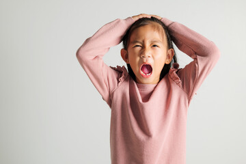 Asian portrait young kid girl standing angry and mad raising fist frustrated and furious while...