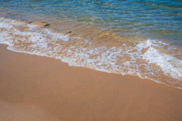 A soft beautiful ocean wave on the sandy beach of Nha Trang