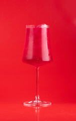 tropical italian soda cocktail glass refreshing strawberry red fruits on red background