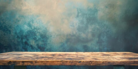 a simple wooden table with a blurred, artistic background featuring subtle tones.