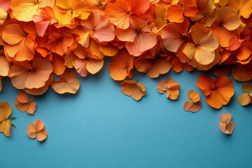 Obraz premium Fragmented marigold petals scattering across a light pastel blue surface,