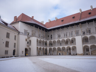 Fototapeta premium historical architecture and snowy square inside Wawel Castle in krakow old city