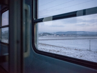snowy scenery of country side seen from the train window in poland