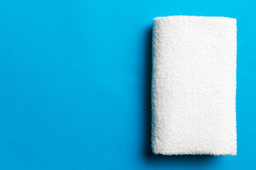 Top view of white towels with copy space on colored background