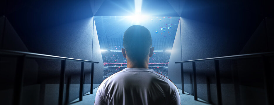 Fototapeta Soccer player entering stadium tunnel before match. Background is an imaginary stadium that is modelled and rendered.