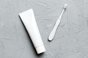 toothpaste and toothbrush top view with copy space on colored background. Flat lay. Dental hygiene. Oral care products on light background. Body care concept