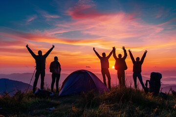 five happy friends standing with arms raised on top of a hill and enjoying the beautiful view during sunrise or sunset
