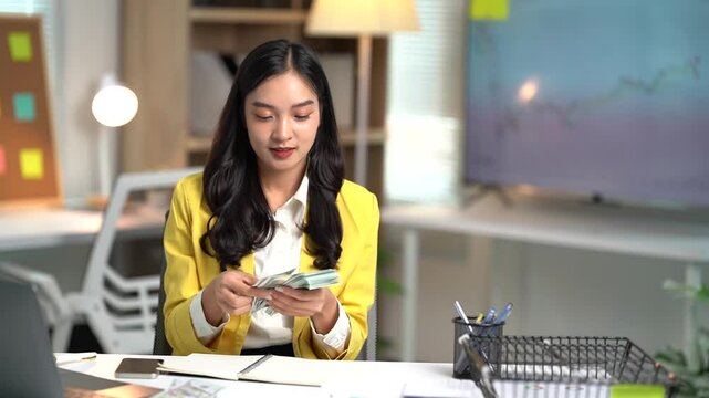Asian businesses women working in the office used laptop and smartphone at her dest 