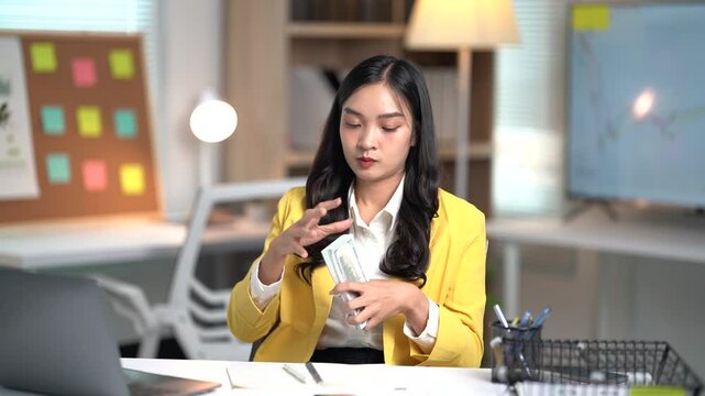 Asian businesses women working in the office used laptop and smartphone at her dest 