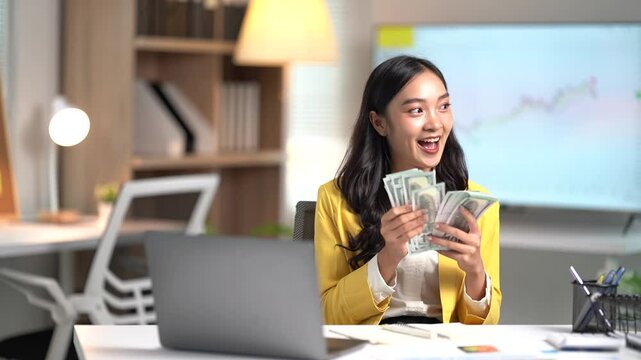 Asian businesses women working in the office used laptop and smartphone at her dest 