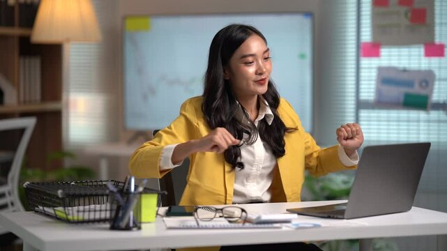 Asian businesses women working in the office used laptop and smartphone at her dest 
