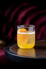Satsuma cocktail in glass on dark background