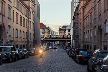 Scenic evening view Geschwister-Scholl street and S-bahn subway train bridge in Berlin Mitte...