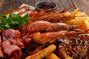 Assorted snacks for beer on a wooden background. selective focus.