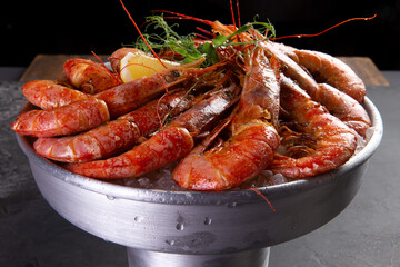 Large cooked shrimp on a dark background.