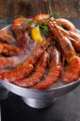 Large cooked shrimp on a dark background.