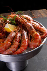 Large cooked shrimp on a dark background.