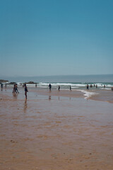 Beach full of people on a sunny summer weekend in Cascais.