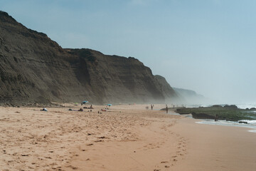 Group of people in the beach at the sunset.