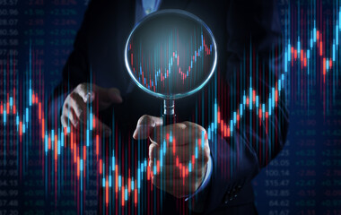 Investor finding the best investment opportunities. Stock market prices and charts. Man holding a...