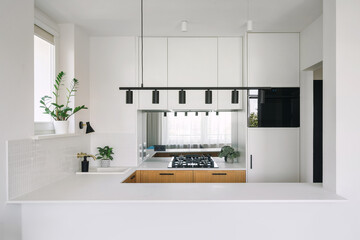 Modern kitchen featuring empty island and white cabinetry