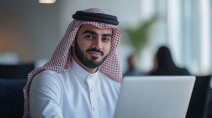Saudi businessman working on a laptop