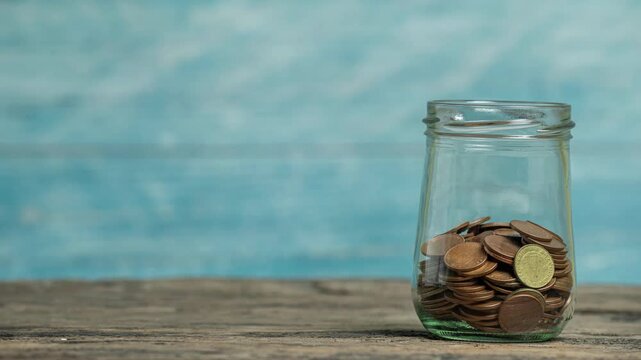 Stack of coins that growing into a graph with bootle or piggy bank, Saving money and account banking for finance concept, 4k