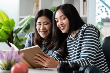 Happy Family Moments: Mother and Daughter Reading Together in a Cozy Home Environment