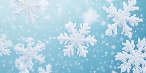 Beautiful close-up of intricate snowflakes falling gently on a light blue background, capturing the essence of winter's delicate beauty.