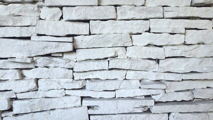 White brick wall texture background. Exterior rock brick wall. Close up of a white brick-wall.