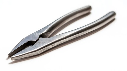 Fototapeta premium A single pair of pliers, closed and positioned diagonally on a bright white background, casting a faint shadow. 