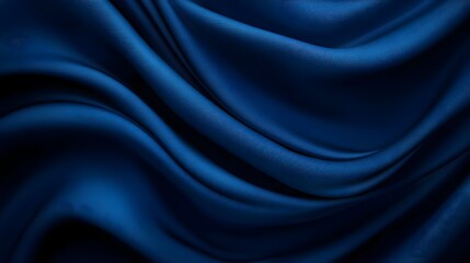 Fototapeta premium Elegant deep blue silk fabric creating soft waves, ideal for luxury design and textile backgrounds.