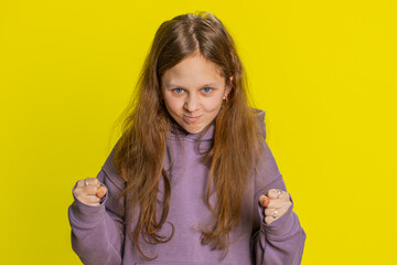 Dissatisfied young preteen child girl kid expressing disbelief irritation, feeling bored nervous, disappointed in result bad news, fail, lose game. Teenager cute children isolated on yellow background