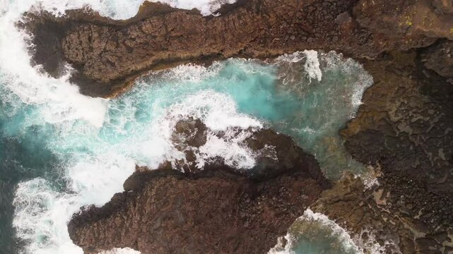 Aerial view of the rugged coastline with crashing waves and rocky cliffs, Lomo Machin, La Palma, Spain.