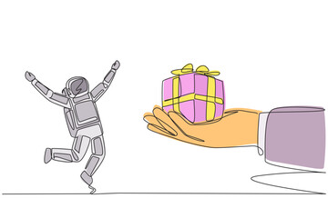 Single continuous line drawing astronaut excited to get the gift box from the giant hand. Neatly wrapped in cardboard. Decorated with ribbon. Special gift. Success. One line design vector illustration