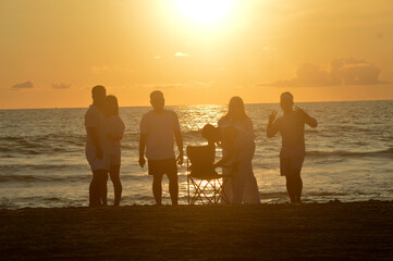 Party people by the beach with the beautiful sunset