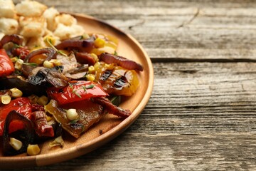 Delicious salad with grilled vegetables on wooden table, closeup. Space for text