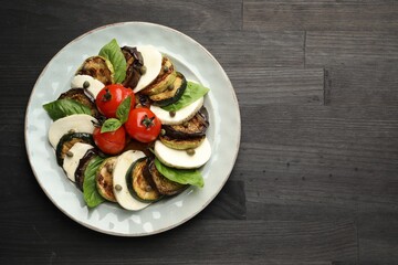 Tasty salad with grilled vegetables and mozzarella cheese on wooden table, top view. Space for text