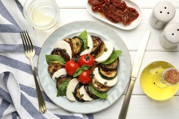 Tasty salad with grilled vegetables and mozzarella cheese served on white wooden table, flat lay