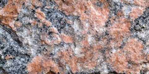 Natural granite rock formation showcasing vibrant pink and gray mineral patterns in sunlight