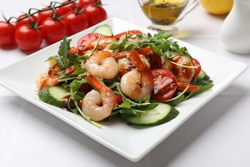 Delicious shrimp salad with vegetables on white table, closeup